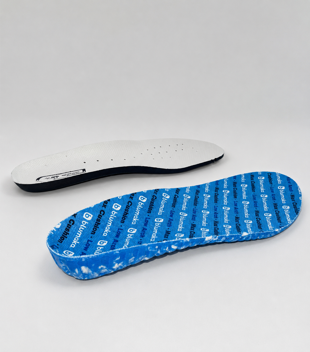 A thin flat factory insole beside the thick sculpted Blumaka Performance insole