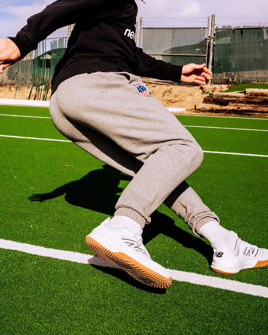 An athlete planting and cutting on turf