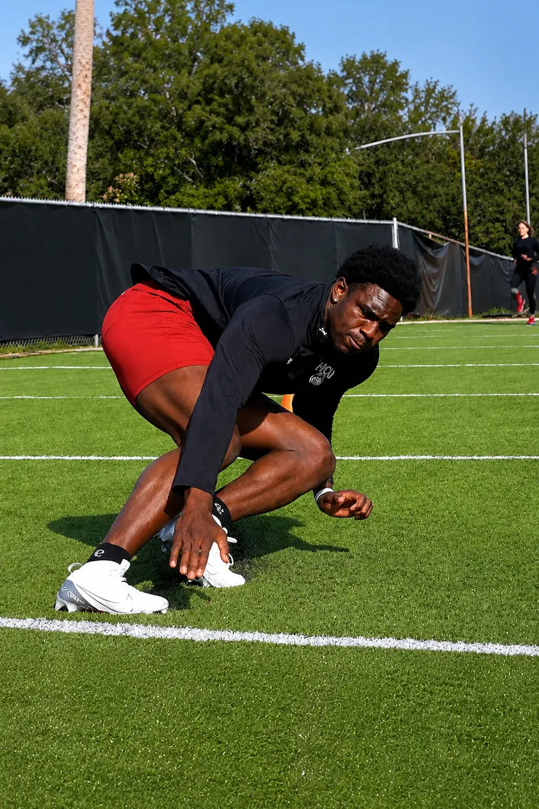 Jalyx Hunt in a three-point stance on the field