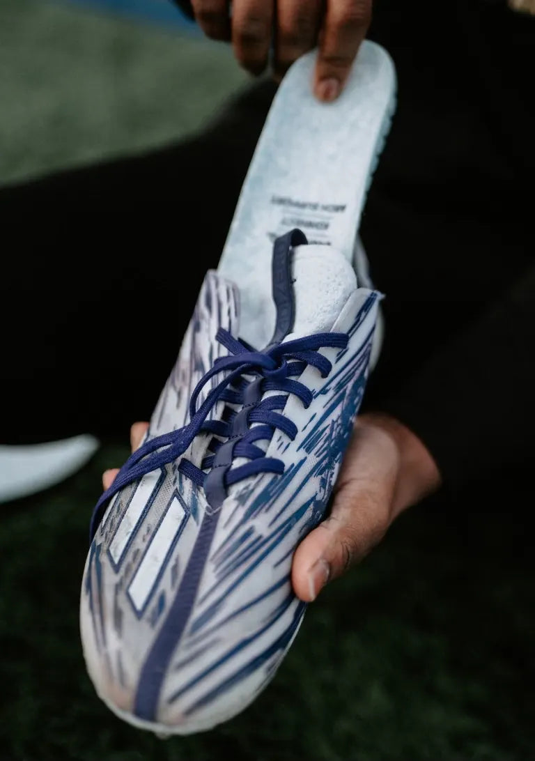Sliding a Blumaka NonSlip insole into a football cleat