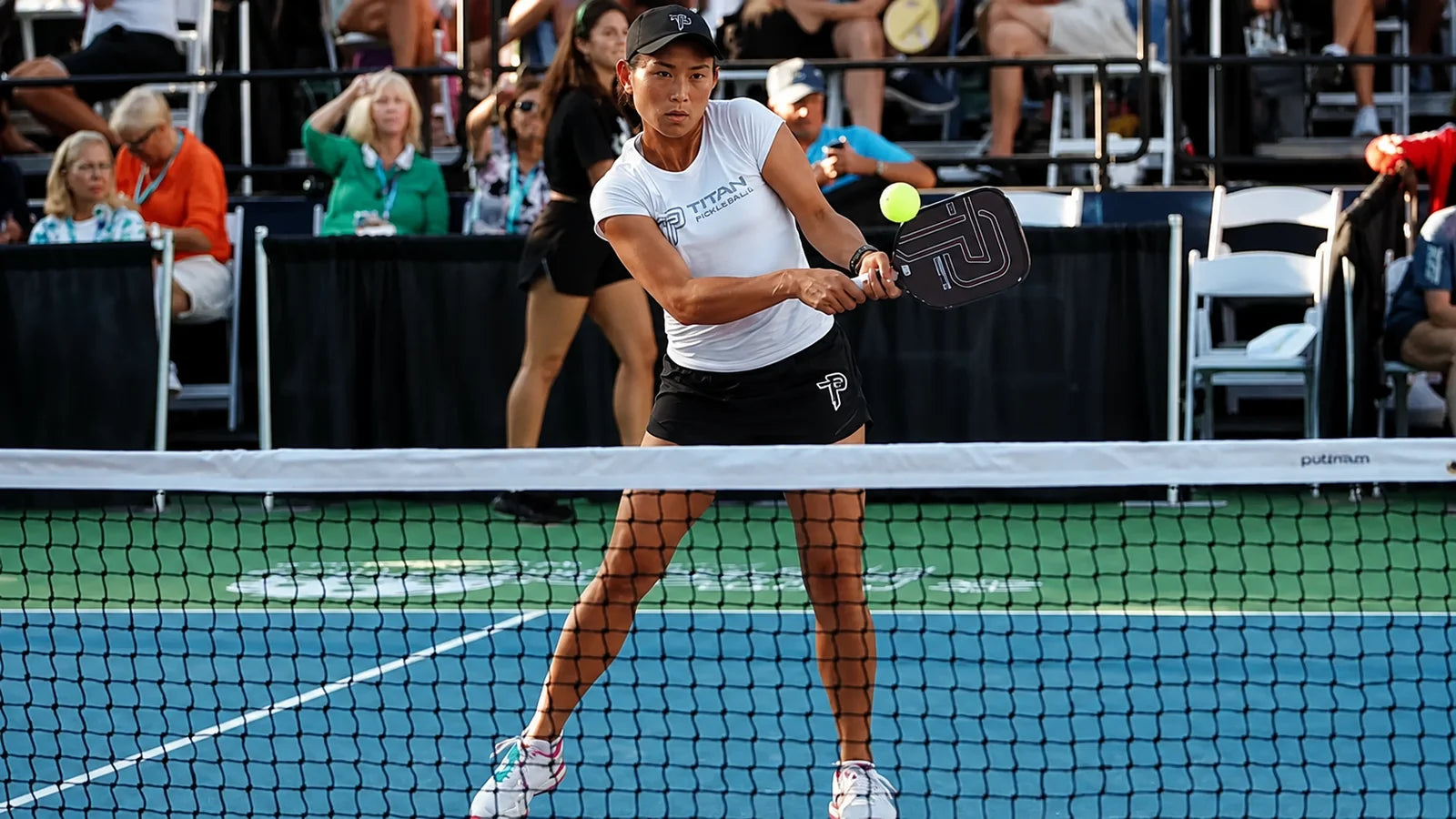 Trang Huynh-McClain driving a backhand at the net