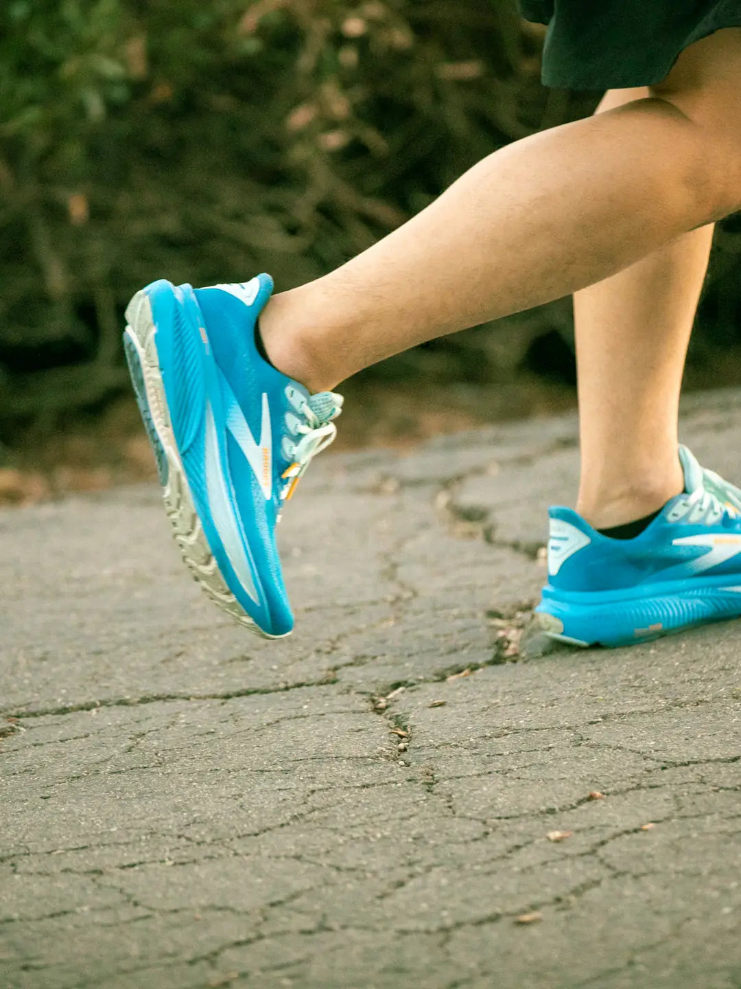 Runner's foot striking the ground mid-stride