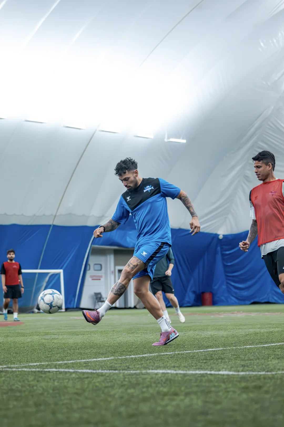 Adil Gowani cutting with the ball indoors