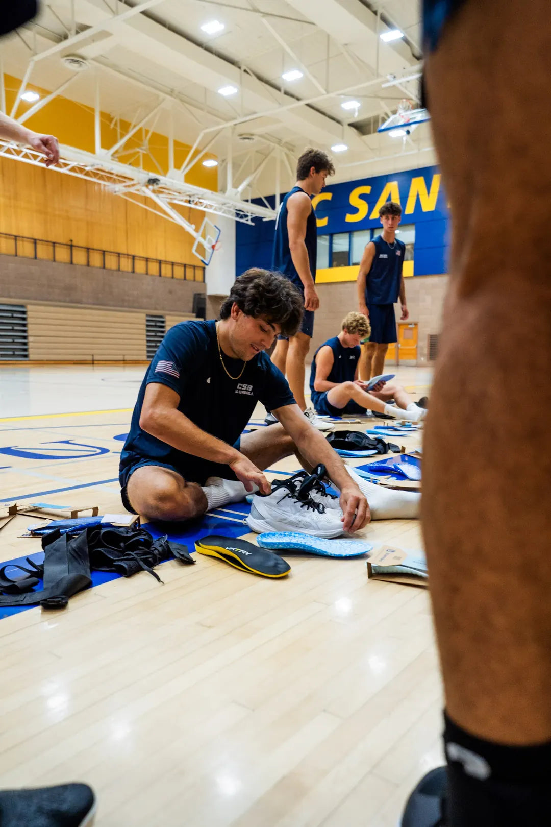 Sliding a Blumaka NonSlip insole into a volleyball shoe