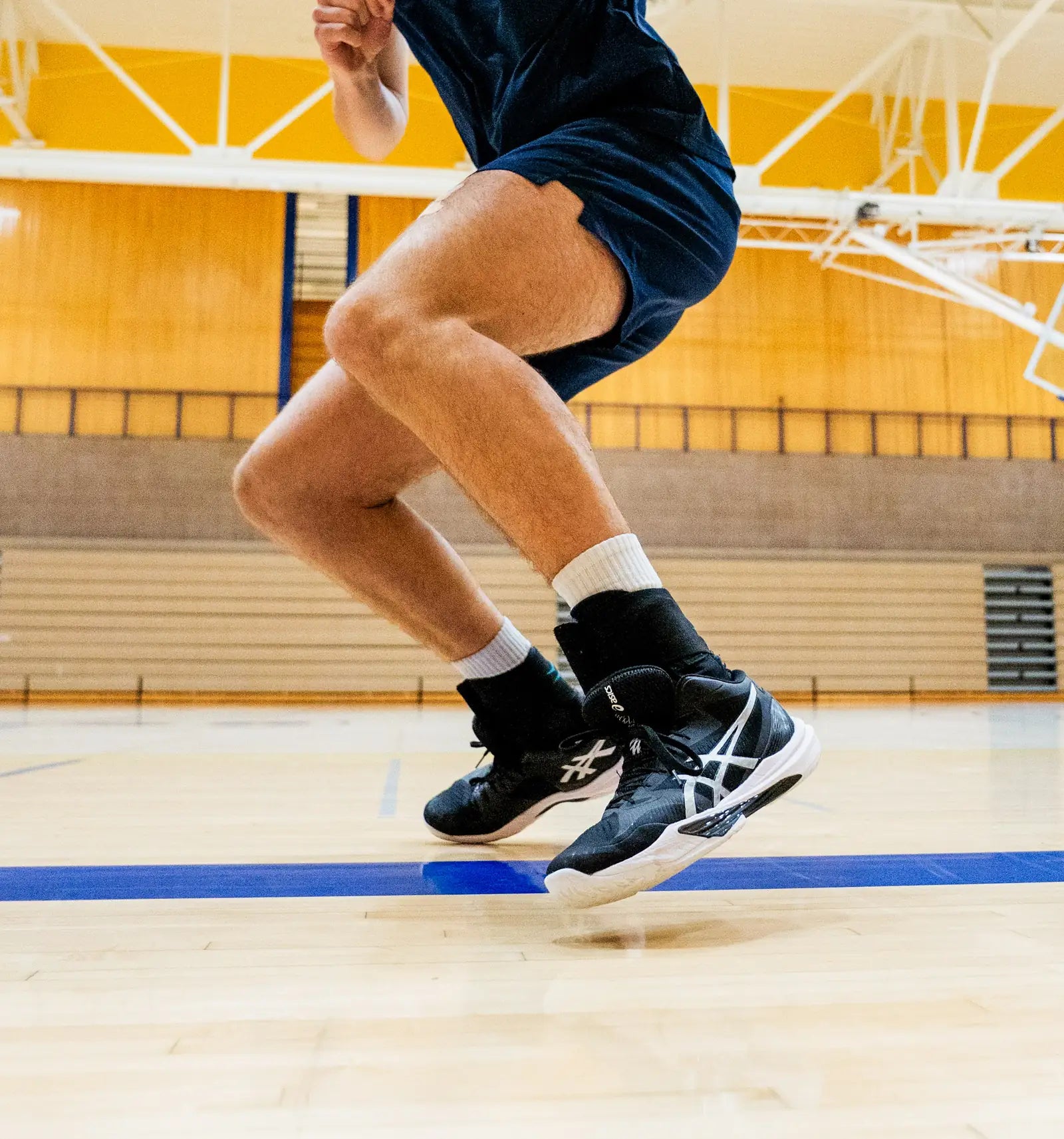 Volleyball player leaving the floor on a jump
