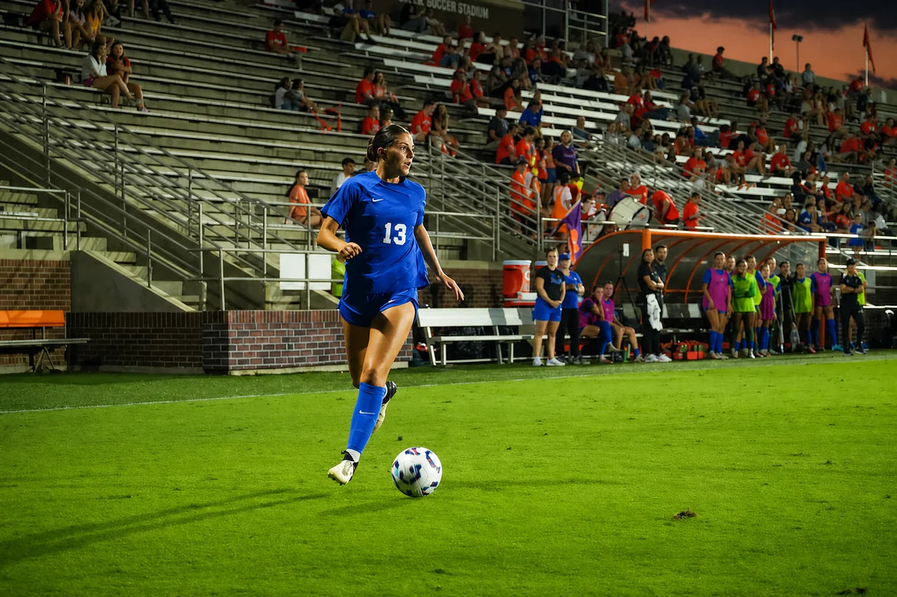 Mia Minestrella driving up the field with the ball
