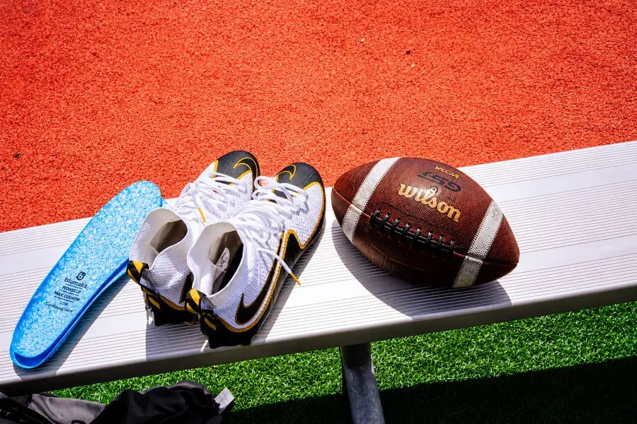 Blumaka NonSlip insoles next to a pair of football cleats