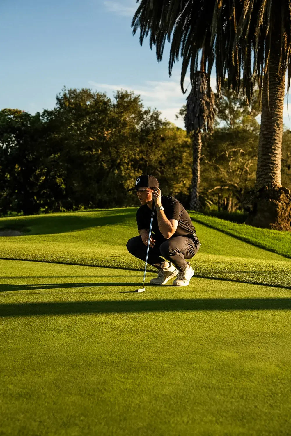 Connor Moore reading a putt on the green