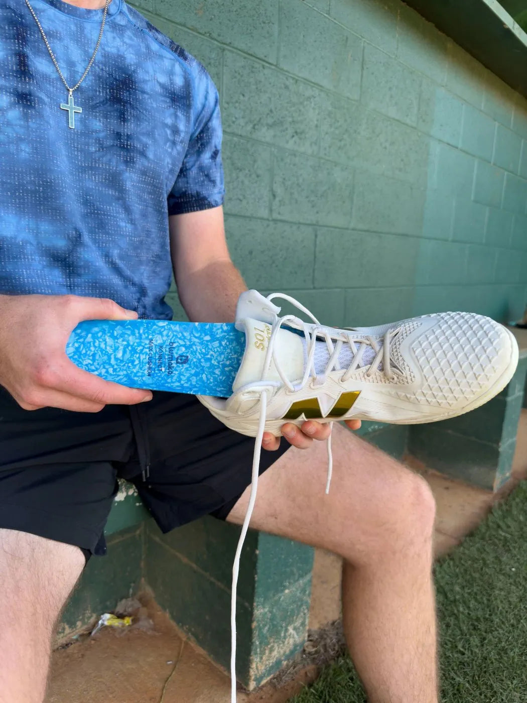 Blumaka NonSlip insole being dropped into TJ Shook's cleat